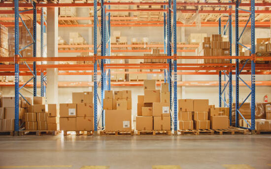 Large Retail Warehouse full of Shelves with Goods in Cardboard Boxes and Packages without People. Logistics, Sorting and Distribution Facility for Product Delivery.